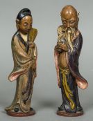 A pair of Chinese terracotta figures Modelled as a sage and his female companion,