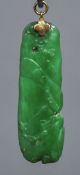 A small Chinese gold mounted apple green jade pendant Carved with a bird on a rocky outcrop. 4.