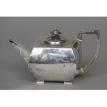 A George III silver teapot, hallmarked London 1802, maker's mark of IR Of squat square form,
