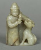 A Chinese carved celadon and russet jade figure Worked as a Middle Eastern gentleman and his dog.