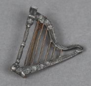 An unmarked yellow and white metal diamond set brooch Formed as harp. 4.5 cm high.