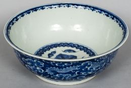 A Chinese blue and white porcelain bowl Decorated with dragons amongst stylised clouds,