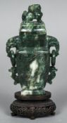 A Chinese carved spinach green jade vase and cover The removable cover mounted with a dog-of-fo,