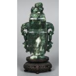 A Chinese carved spinach green jade vase and cover The removable cover mounted with a dog-of-fo,