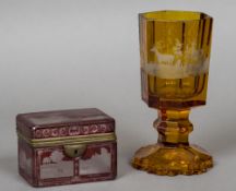 An amber coloured Bohemian glass goblet Engraved in the round with deer;