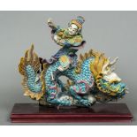 A Chinese pottery figural group Modelled as a male figure in flowing robes and a headdress riding a