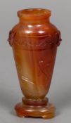 A late 19th/early 20th century Oriental carved Carnelian vase With twin mask mounted shoulders