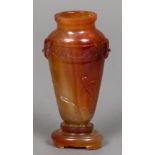 A late 19th/early 20th century Oriental carved Carnelian vase With twin mask mounted shoulders