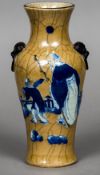 A 19th century Chinese porcelain vase With twin ring and mask handles decorated with a scholar and