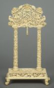 A late 19th century Canton carved ivory watch stand Of portico form,