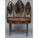 An Edwardian mahogany dressing table Of crossbanded oval form with three bevelled mirrors above two