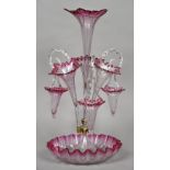 A Victorian clear and cranberry glass epergne Each trumpet vase interspersed with a spiral moulded