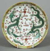 A Chinese famille verte porcelain plate Decorated with two five clawed dragons chasing flaming