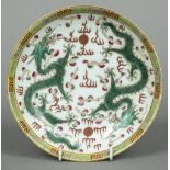 A Chinese famille verte porcelain plate Decorated with two five clawed dragons chasing flaming