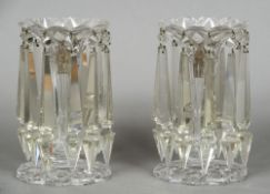 A pair of Victorian cut glass candle lustres Of typical form, each with ten pendant prisms. 22.