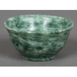 A Chinese hardstone, possibly jade, bowl Of flared form, with a stepped foot. 10 cm diameter.