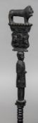 A Nigerian colonial carved walking stick The handle formed as a lion beneath the inscription Dr.