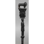 A Nigerian colonial carved walking stick The handle formed as a lion beneath the inscription Dr.