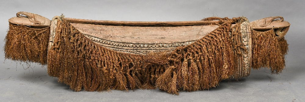 A large Papua New Guinea tribal split drum Of carved oval spherical form,