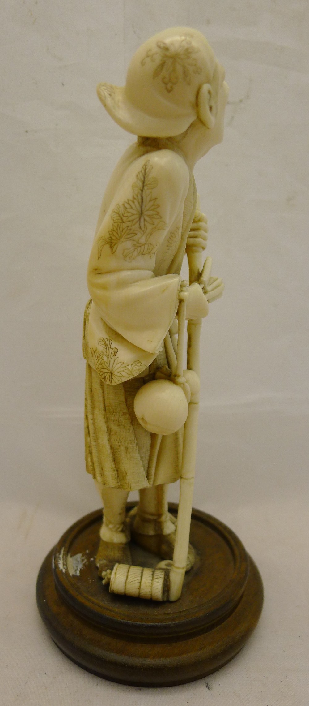 A 19th century Japanese ivory okimono Formed as a male figure holding a stick and a fan with a - Image 3 of 7