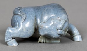 A Chinese carved turquoise and russet hardstone stallion Worked in a semi-recumbent pose.