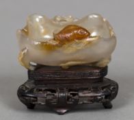 A 19th century Chinese carved agate brush washer Of natural form, carved with a fish and a crab,