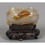 A 19th century Chinese carved agate brush washer Of natural form, carved with a fish and a crab,