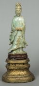 An antique Chinese jade carving of Guanyin Typically modelled wearing flowing robes,