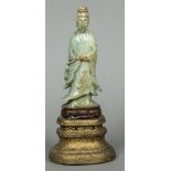 An antique Chinese jade carving of Guanyin Typically modelled wearing flowing robes,