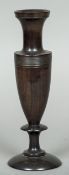 A 19th century Continental turned hardwood vase Of slender urn form with reeded band. 25 cm high.