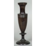 A 19th century Continental turned hardwood vase Of slender urn form with reeded band. 25 cm high.
