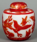 A Peking overlay glass jar and cover Decorated in the round with birds and butterflies amongst