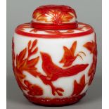 A Peking overlay glass jar and cover Decorated in the round with birds and butterflies amongst