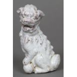 A Chinese porcelain model of a temple lion Modelled seated with allover white crackle glaze.