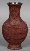 A late 19th/early 20th century Chinese cinnabar lacquered vase With flared neck rim above the ovoid