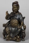 A Chinese gilt and polychrome decorated cast bronze figure of an emperor Modelled seated on a