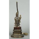 A Chinese carved agate model of Guanyin Modelled holding a vase,