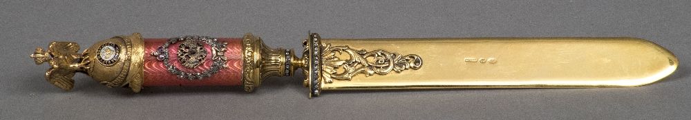 A Russian diamond and ruby set guilloche enamel decorated silver gilt letter opener The handle