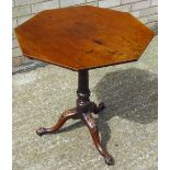 A George III mahogany tilt top tripod table The octagonal top above the carved and turned column,