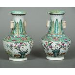 A pair of Chinese porcelain vases Each lappet decorated neck with twin lug handles over a band of