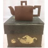 A Chinese Yixing pottery teapot and cover Of trapezoid section with angular handle and spout,