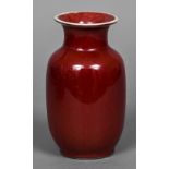 A Chinese sang de boeuf vase The flared neck rim above the plain ovoid body,