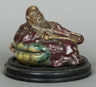 A Chinese pottery figure Modelled as a sage, with mottled glaze, impressed seal mark to base,