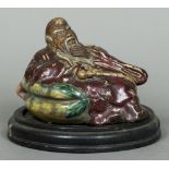 A Chinese pottery figure Modelled as a sage, with mottled glaze, impressed seal mark to base,