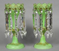 A pair of Victorian green glass and gilt decorated lustre vases Each with shaped rim and ten