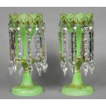 A pair of Victorian green glass and gilt decorated lustre vases Each with shaped rim and ten