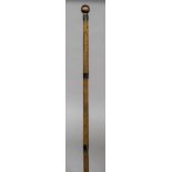An unusual 19th century Eastern walking stick The stained ivory finial above the figural numerical