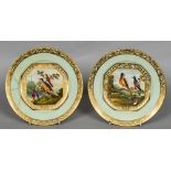 A pair of early 19th century Derby porcelain plates Centrally painted with exotic birds,