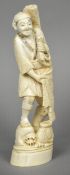 A late 19th/early 20th century Japanese carved ivory okimono Worked as a jovial fisherman.