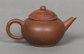 A small Chinese Yixing pottery teapot Impressed mark to base. 5.5 cm high.